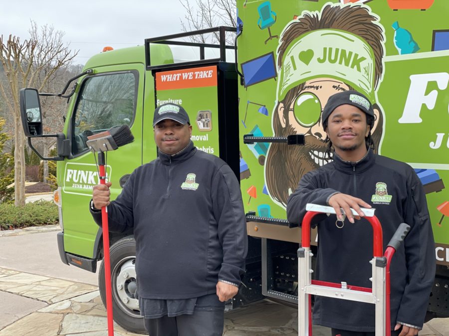 funky's junk removal crew holding equipment that is needed to haul junk