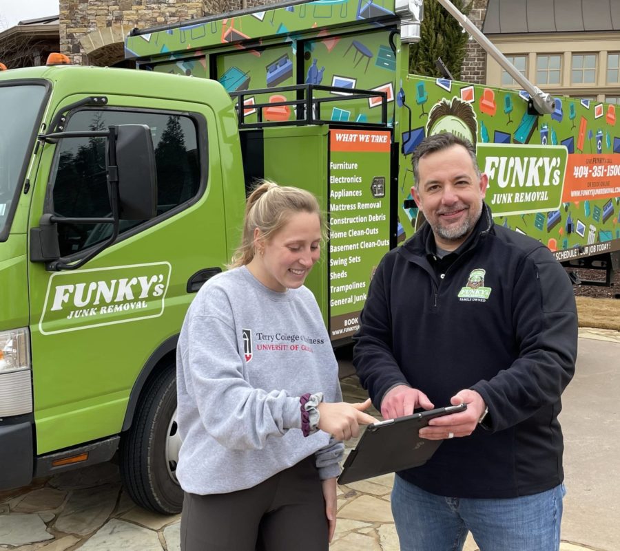 A Funky's Junk Removal pro assisting a customer with pricing
